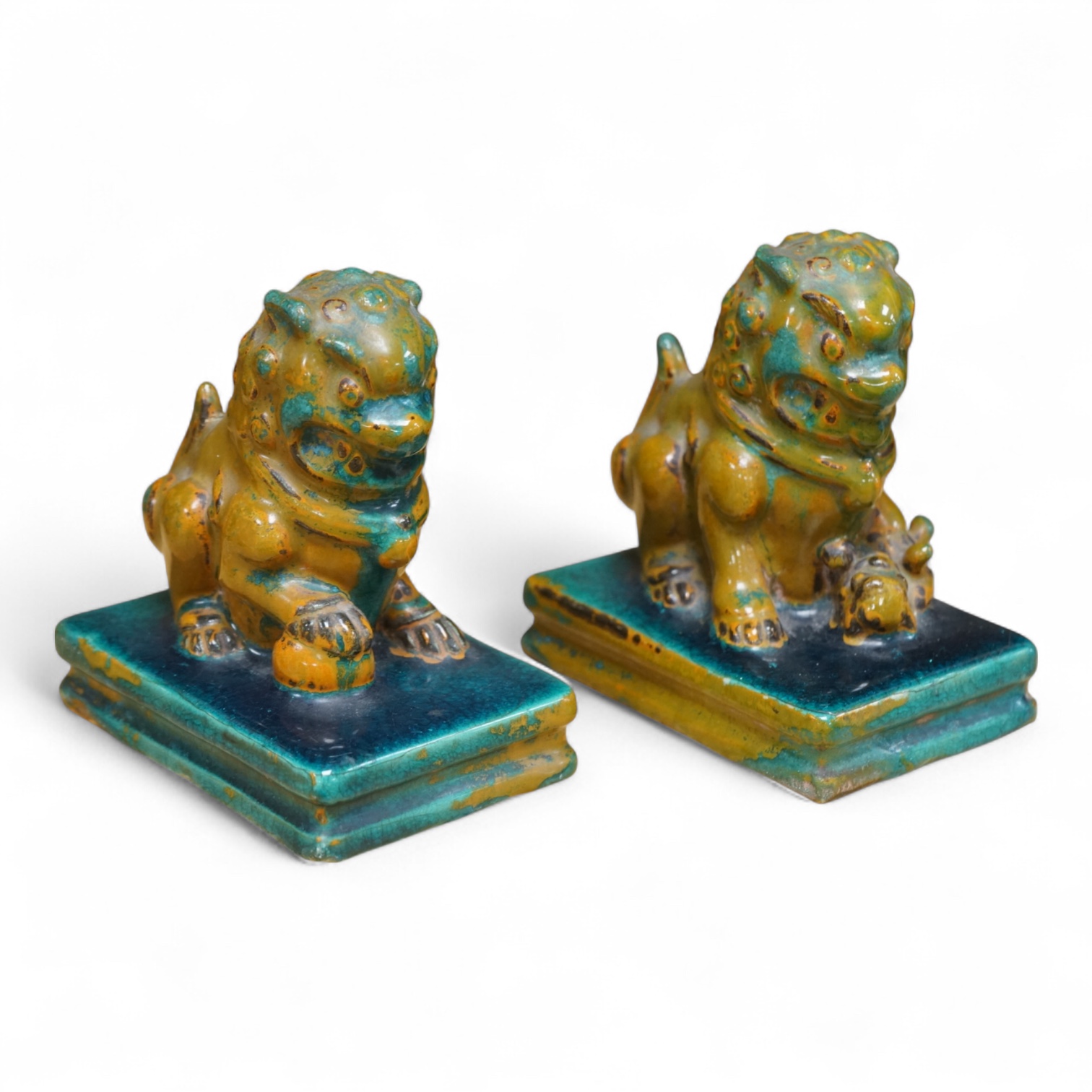 A pair of Chinese turquoise and olive green glazed ceramic lion dogs, Guandong kilns, 19th/20th century, impressed mark, 12cm